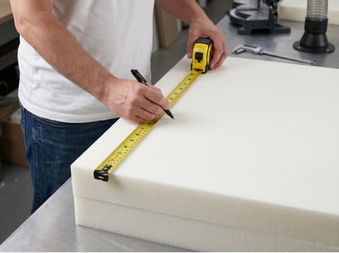 worker measuring custom size foam