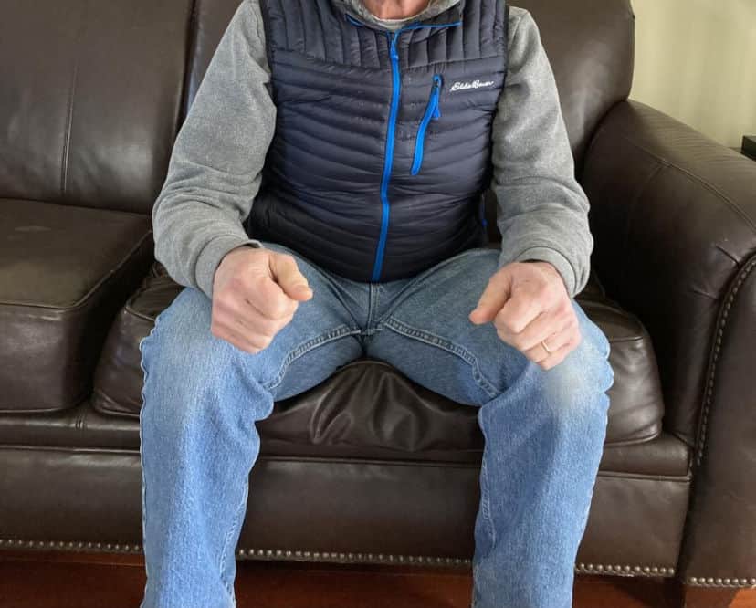 man sitting on a couch cushion demonstrating the density of his sofa seat cushion