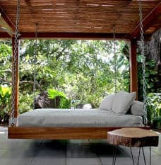 Hanging Wooden Bed with White Mattress and Cushions