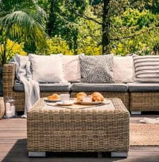 Wicker Couch with Grey Cushions in the Garden